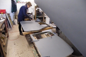 BNAPS Restoration Team member, Rita Edgcumbe, is seen here applying etch primer to one of the passenger doors, the pilot’s door in the fore ground has already been painted, March, 2014  © Bob Wealthy