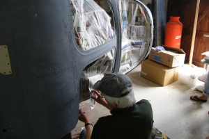 Andy Stewart masks up the fuselage nose section for spray painting, August, 2014.  © Bob Wealthy